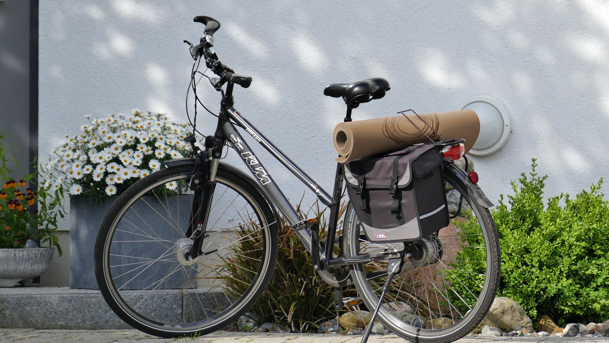 black bicycle with yoga mat