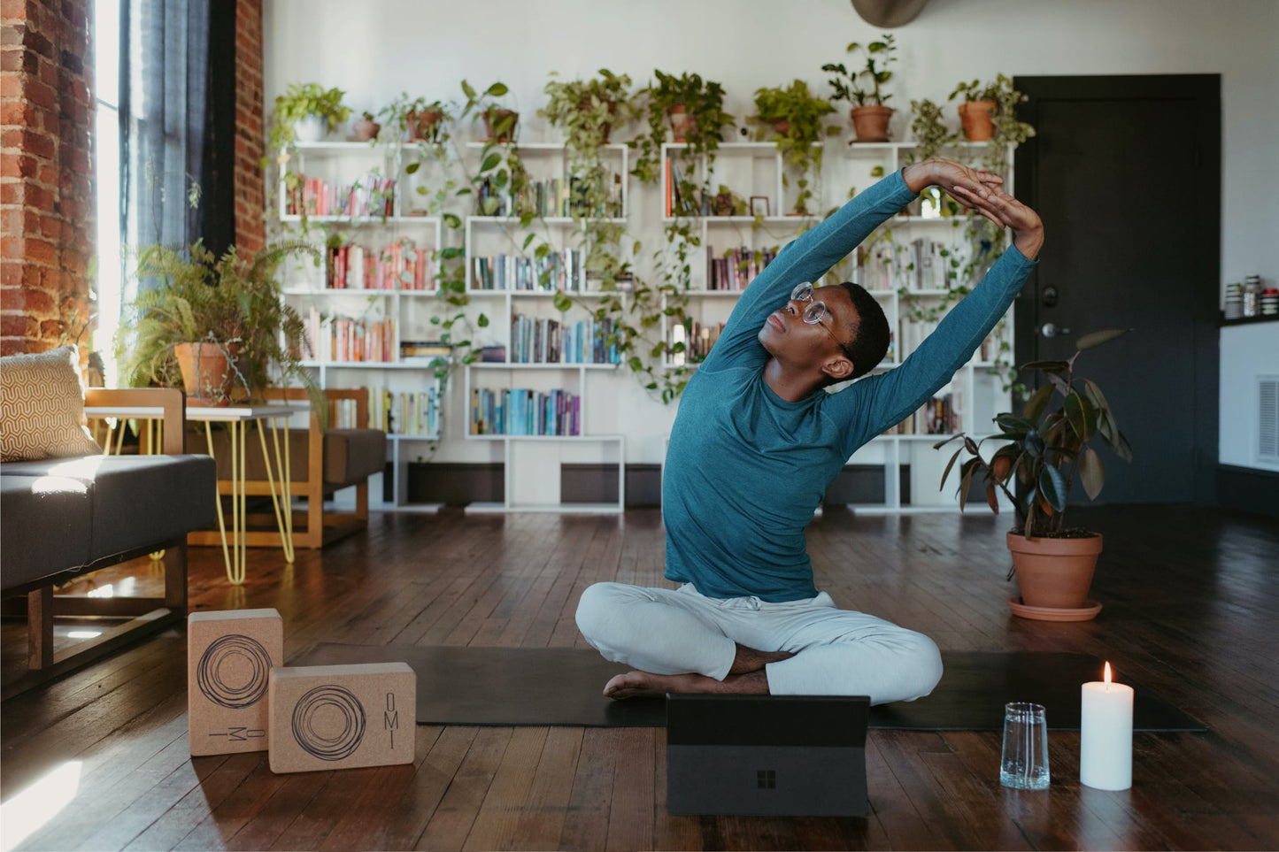 young man stretching on yoga mat