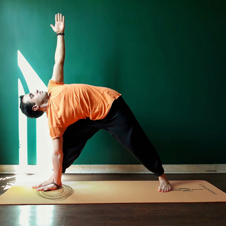 yogi stretching on OMI Essentials cork yoga mat